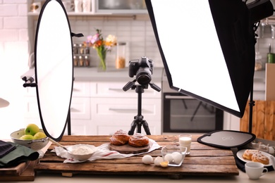 Photo of Professional photo equipment and food composition on table in studio