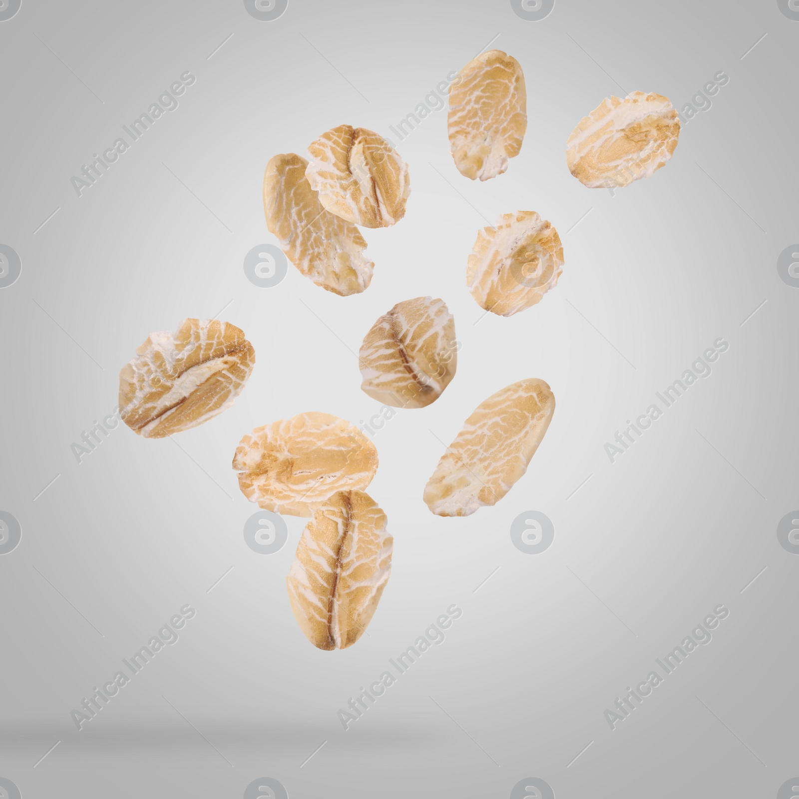 Image of Rolled oat flakes falling on grey background