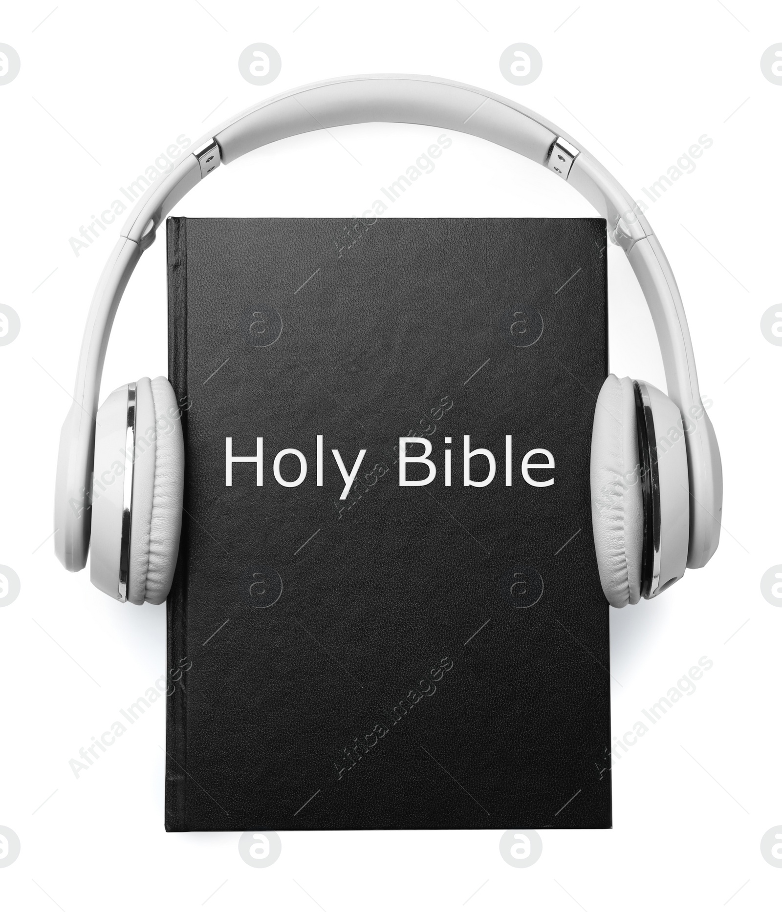 Photo of Bible and headphones on white background. Religious audiobook