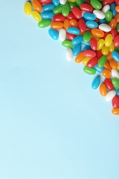 Photo of Flat lay composition with delicious jelly beans on color background. Space for text
