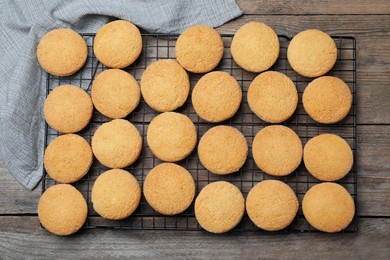 Photo of Many tasty sugar cookies on wooden table, top view