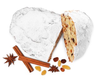 Photo of Cut delicious Stollen sprinkled with powdered sugar and ingredients on white background, top view