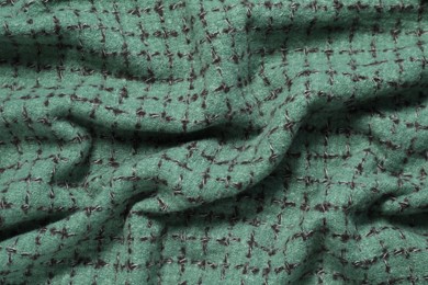 Photo of Soft green scarf as background, top view