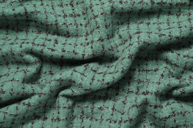 Soft green scarf as background, top view