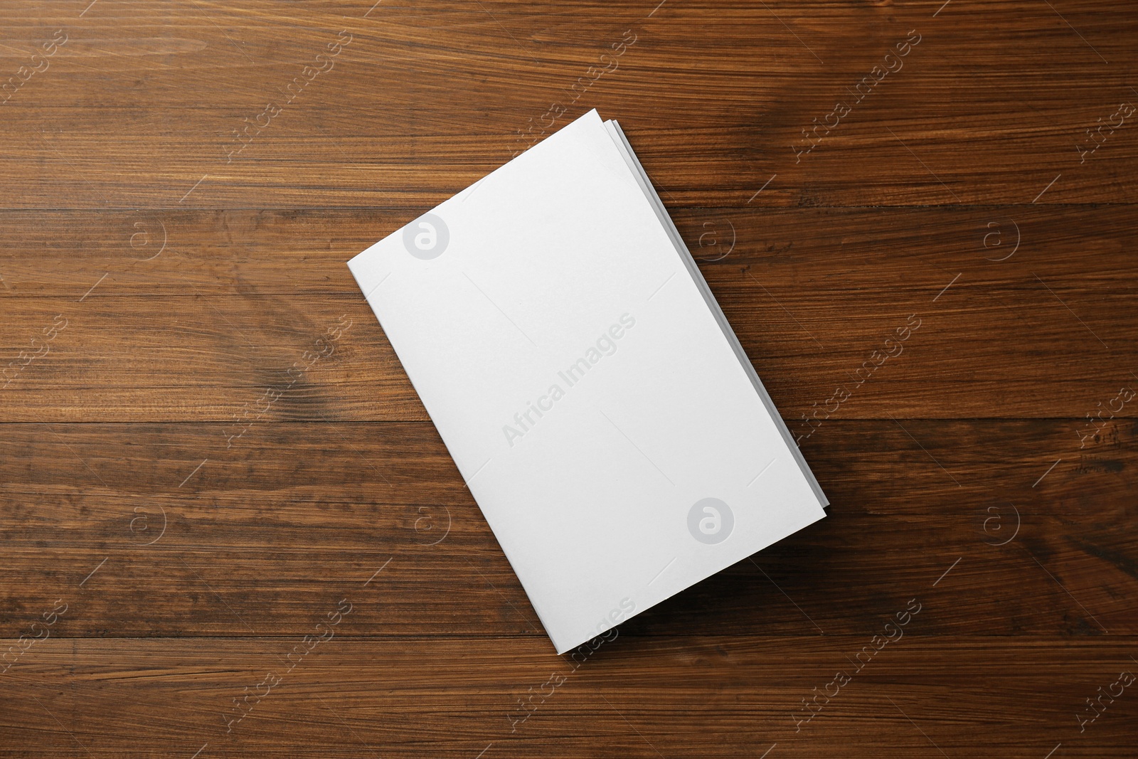 Photo of Blank paper brochure on wooden table, top view. Mockup for design