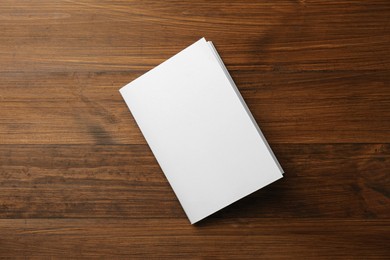 Blank paper brochure on wooden table, top view. Mockup for design