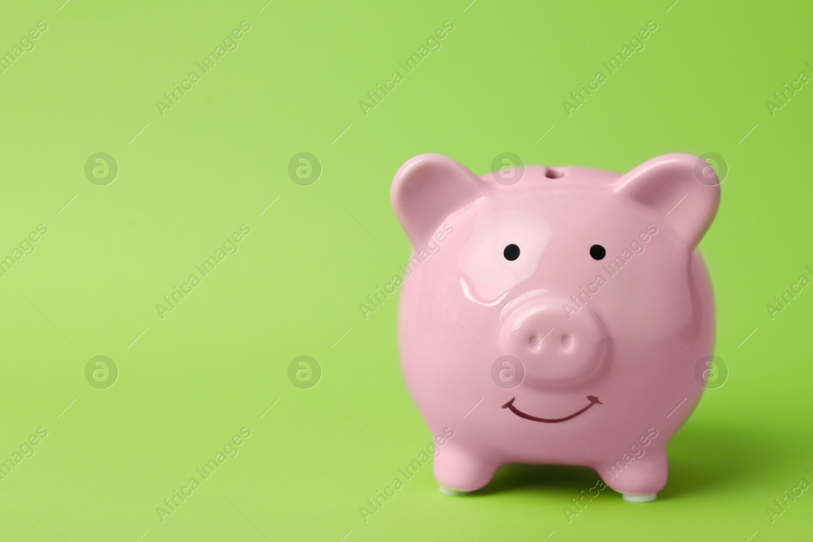 Photo of Pink piggy bank on color background. Money saving