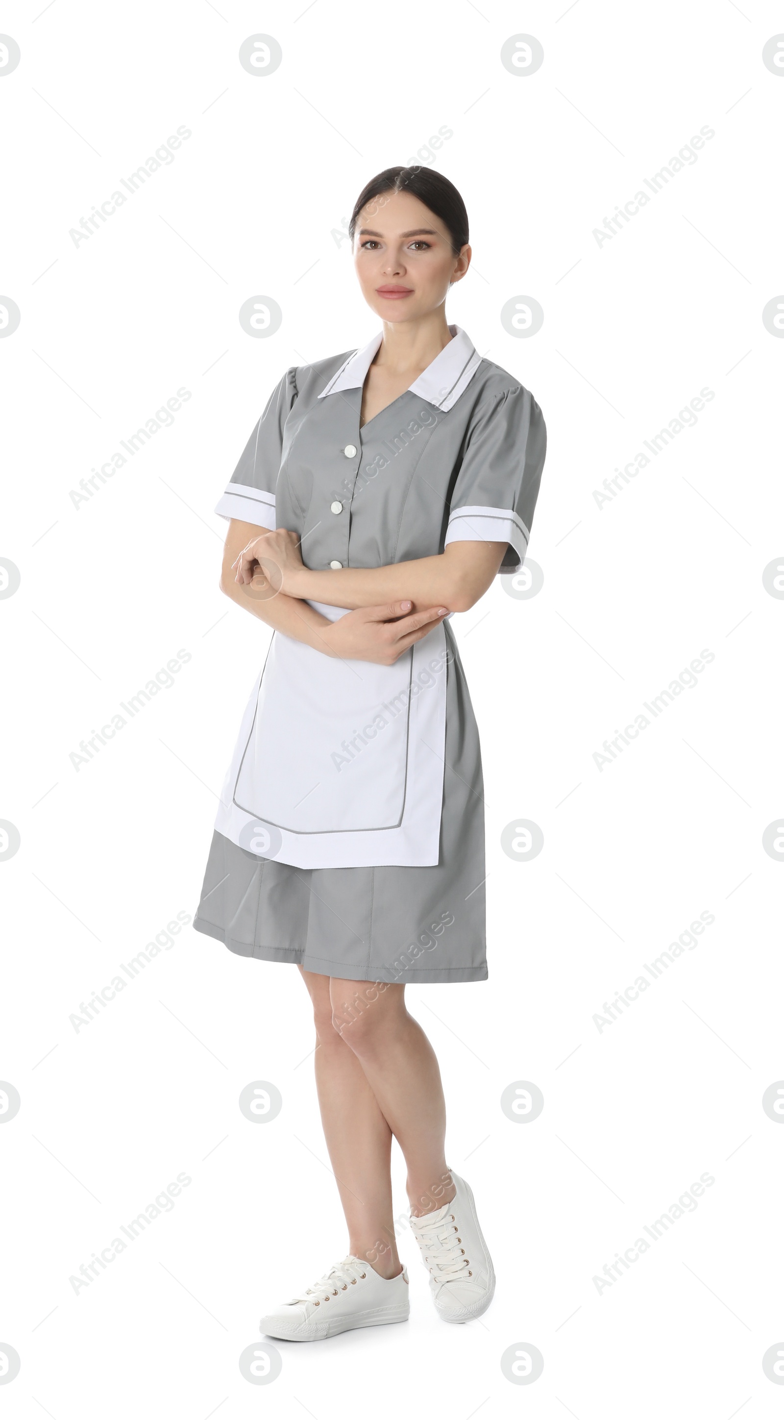 Photo of Young chambermaid in uniform on white background