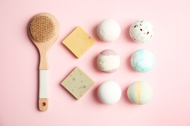Photo of Flat lay composition with bath bombs, brush and soap bars on color background