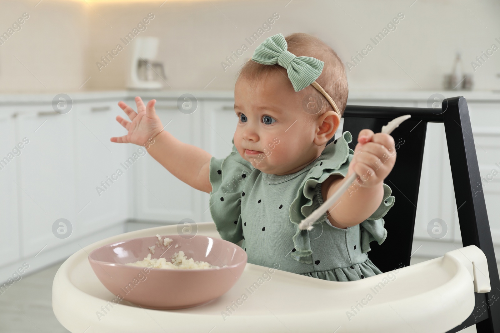 Photo of Cute little girl eating healthy food at home