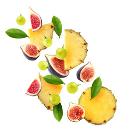 Image of Set of different cut fresh fruits and berries falling on white background