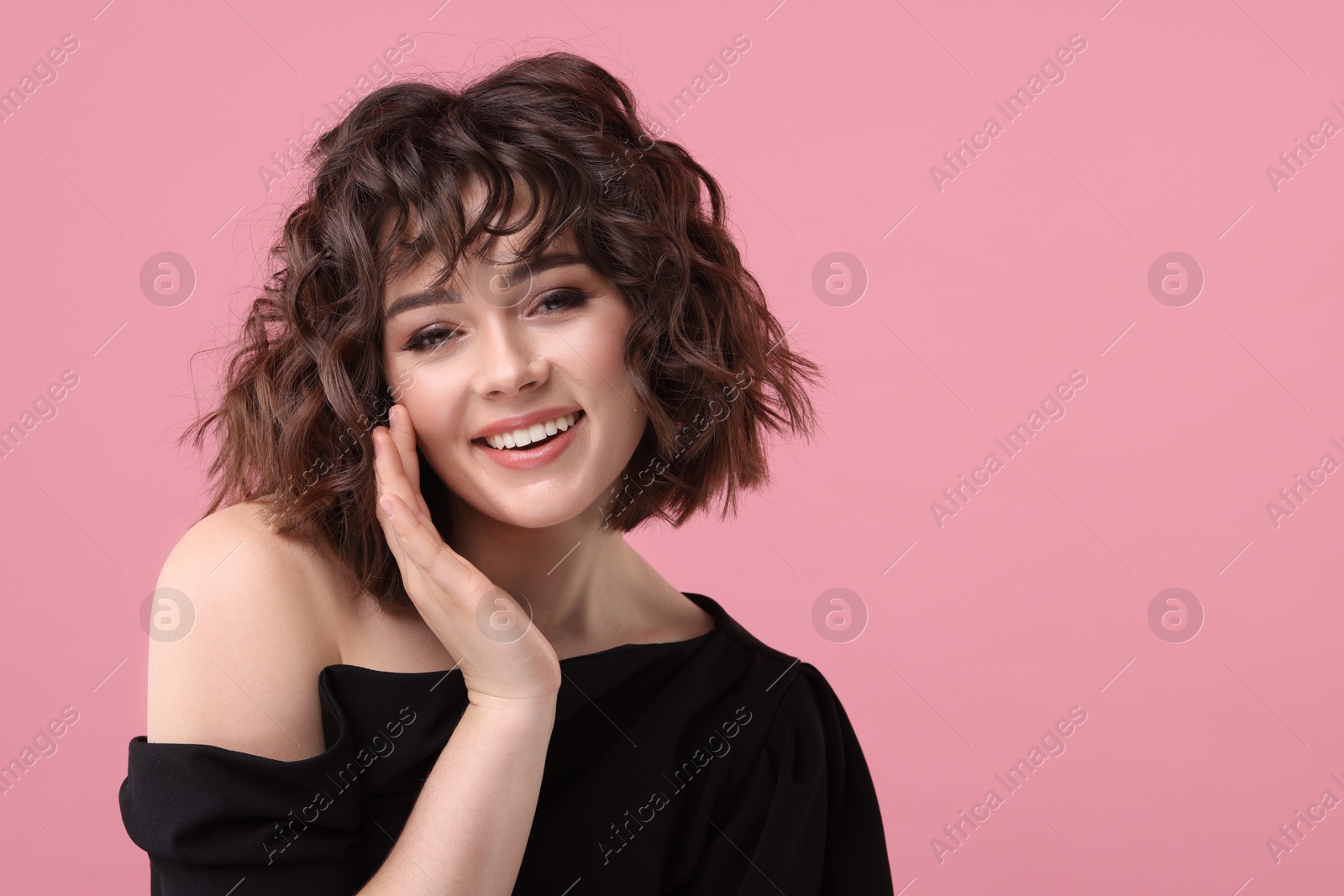 Photo of Portrait of beautiful young woman with wavy hairstyle on pink background. Space for text