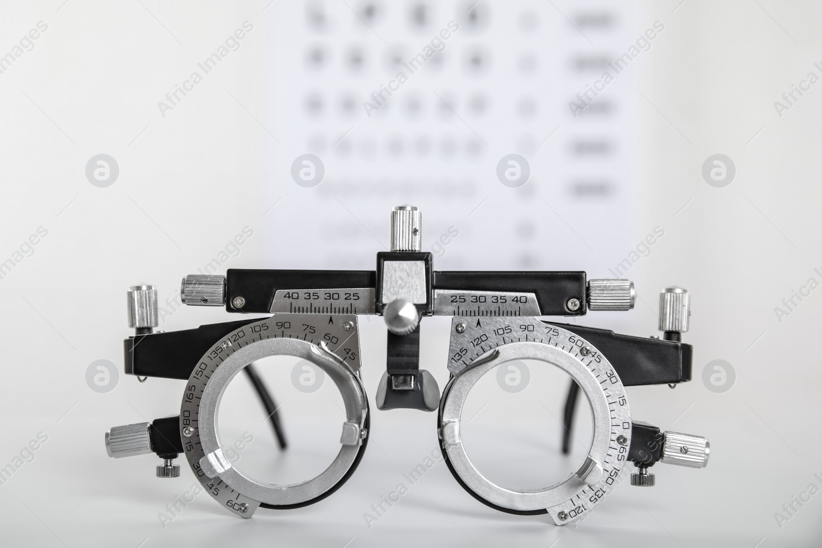 Photo of Trial frame on light background, closeup. Ophthalmologist tool