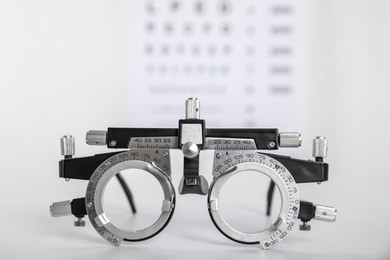 Photo of Trial frame on light background, closeup. Ophthalmologist tool