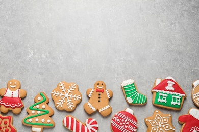 Flat lay composition with tasty homemade Christmas cookies on grey table, space for text