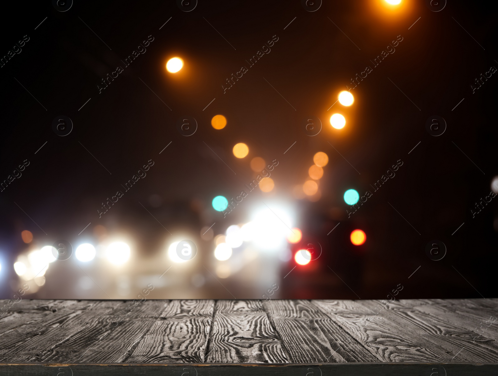 Image of Empty wooden surface against blurred lights. Bokeh effect 