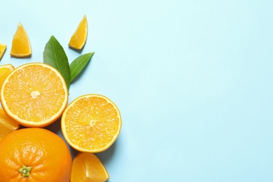 Photo of Flat lay composition with ripe oranges and space for text on color background