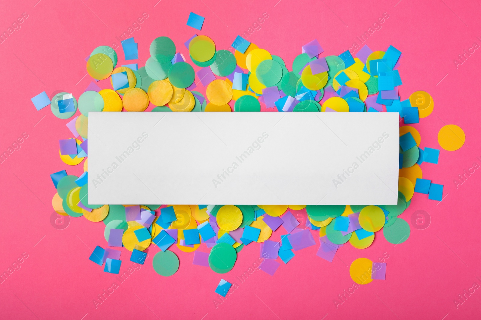 Photo of Blank paper note and confetti on pink background, flat lay with space for text. April Fool's Day