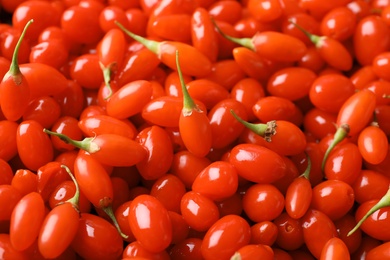 Fresh ripe goji berries as background, closeup