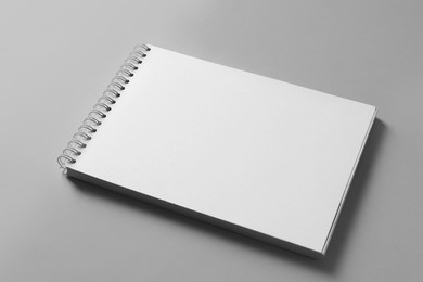 Photo of Blank notebook on light grey background. Mockup for design