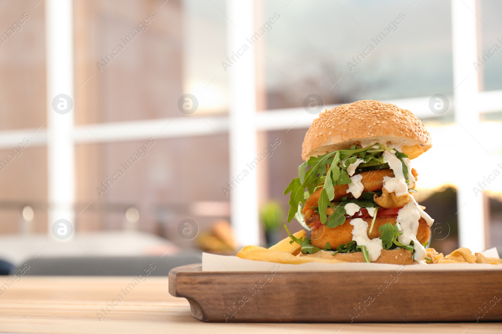 Photo of Huge yummy burger served on table in cafe. Space for text