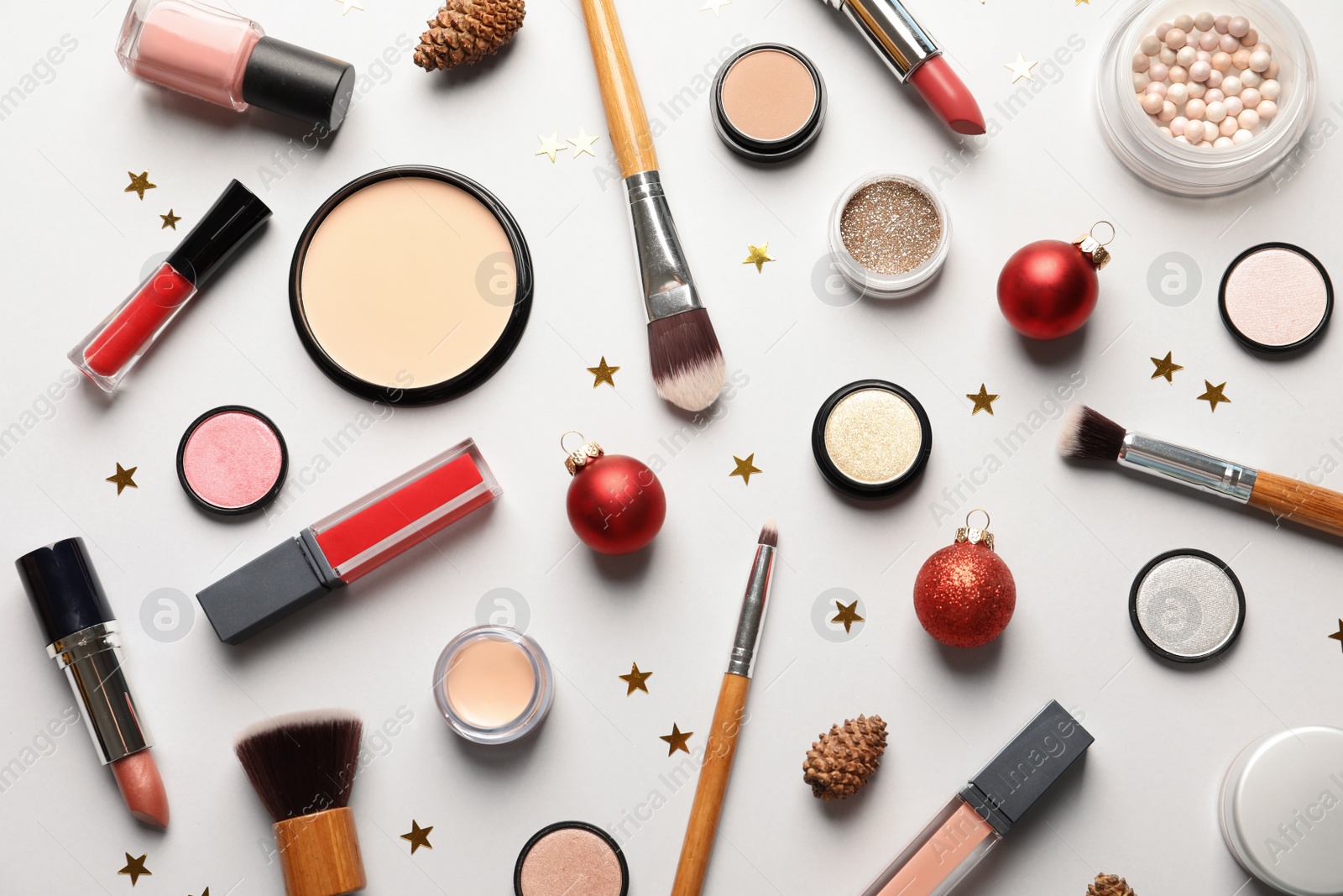 Photo of Flat lay composition with makeup products and Christmas decor on white background