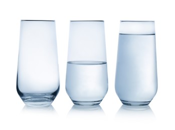 Empty, half and full glasses of water on white background