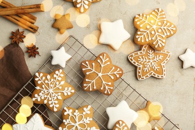 Photo of Tasty Christmas cookies with icing and spices on light table, flat lay