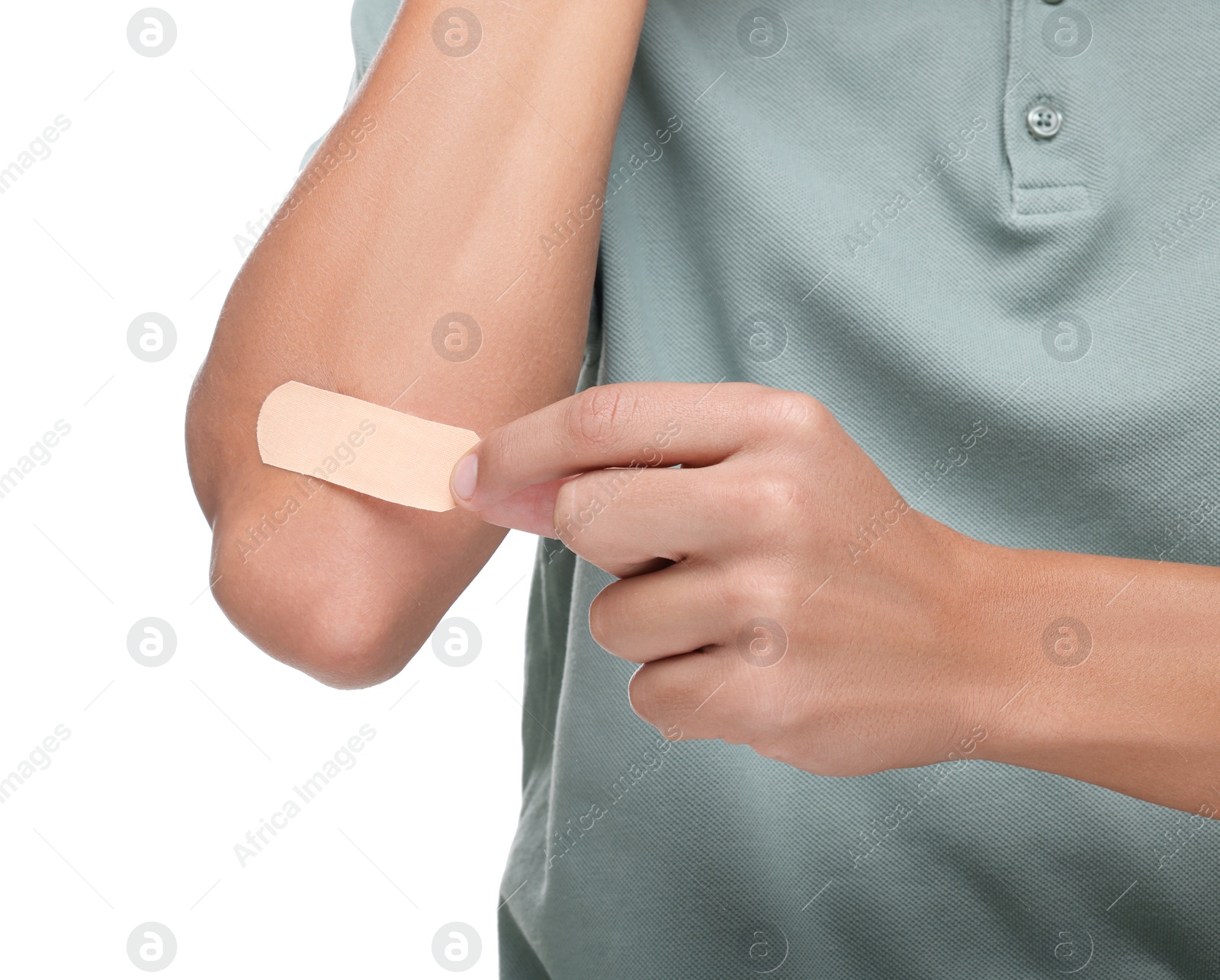 Photo of Man putting sticking plaster onto elbow on white background, closeup