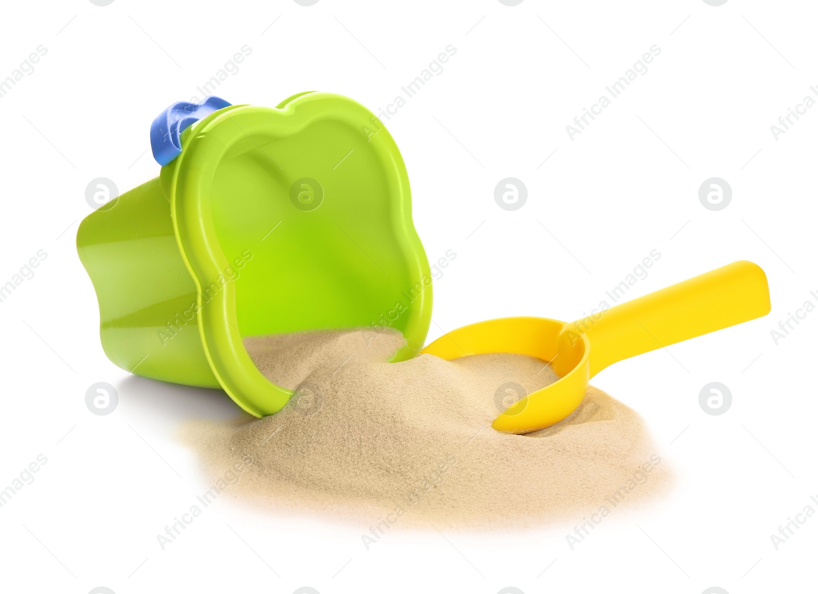 Photo of Plastic beach toys on pile of sand against white background