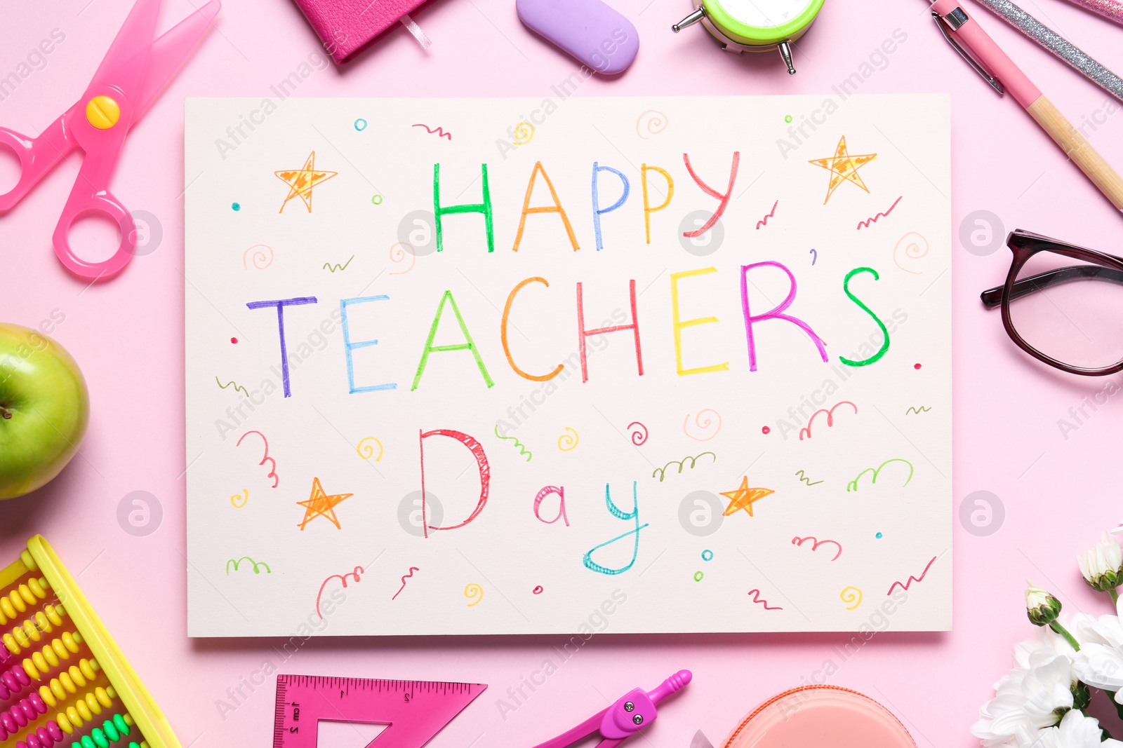 Photo of Flat lay composition of card with inscription HAPPY TEACHER'S DAY and stationery on pink background