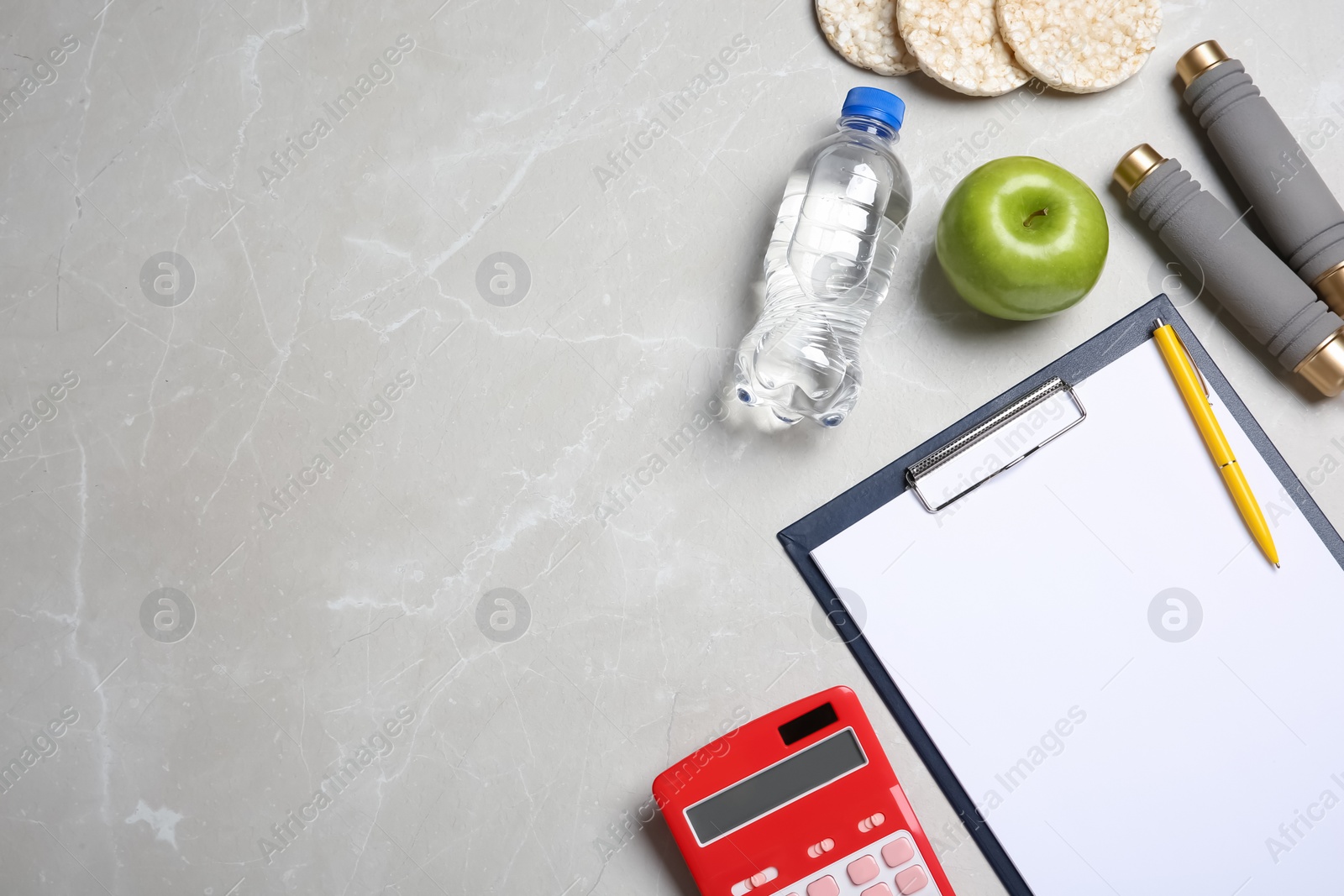 Photo of Flat lay composition healthy food, clipboard, calculator and space for text on grey background. Weight loss concept