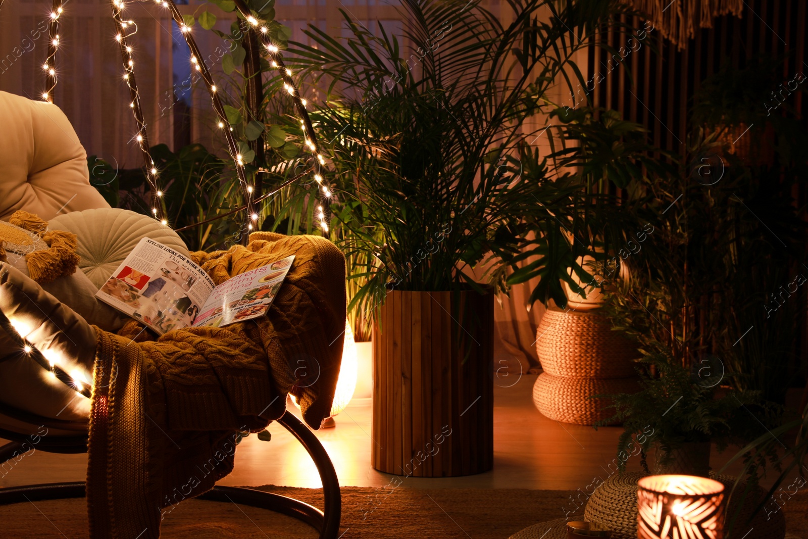 Photo of Indoor terrace interior with comfortable hanging chair and houseplants