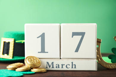 Composition with block calendar on wooden table. St. Patrick's Day celebration