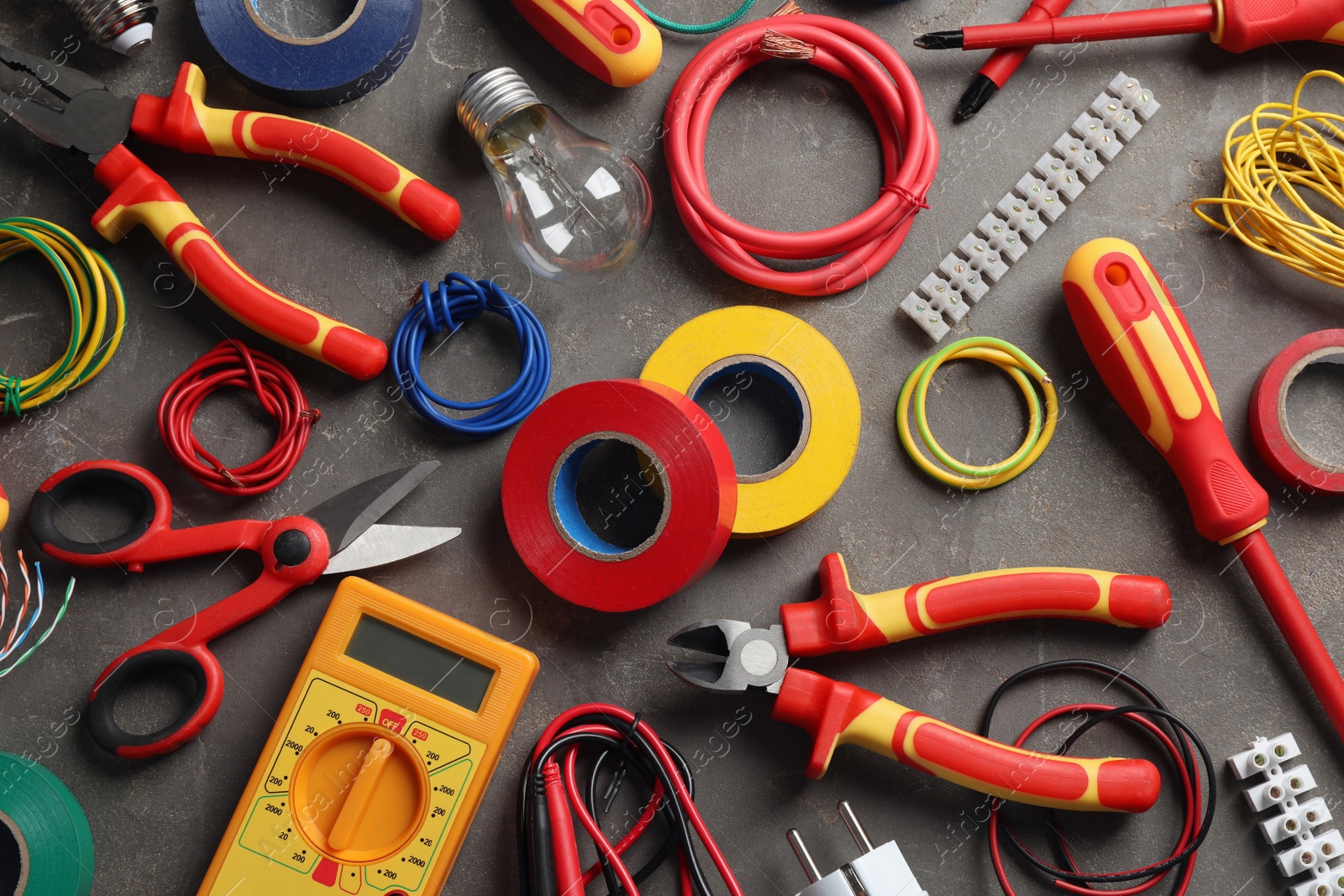 Photo of Flat lay composition with electrician's tools and accessories on grey background