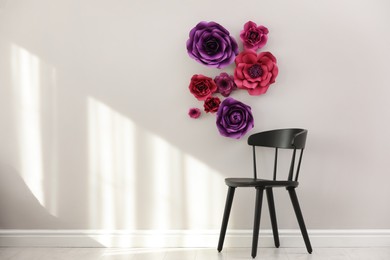 Stylish room interior with floral decor and black chair, space for text