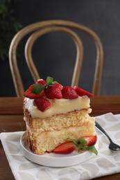 Photo of Piece of tasty cake with fresh strawberries and mint on wooden table