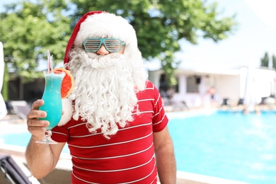 Photo of Authentic Santa Claus with cocktail at resort