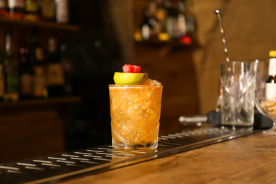 Glass of fresh alcoholic cocktail on bar counter