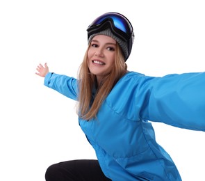 Beautiful woman in ski goggles taking selfie on white background