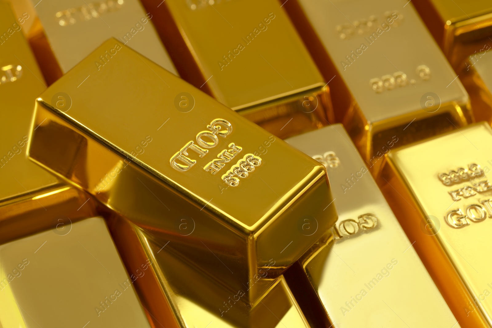 Photo of Many shiny gold bars as background, closeup