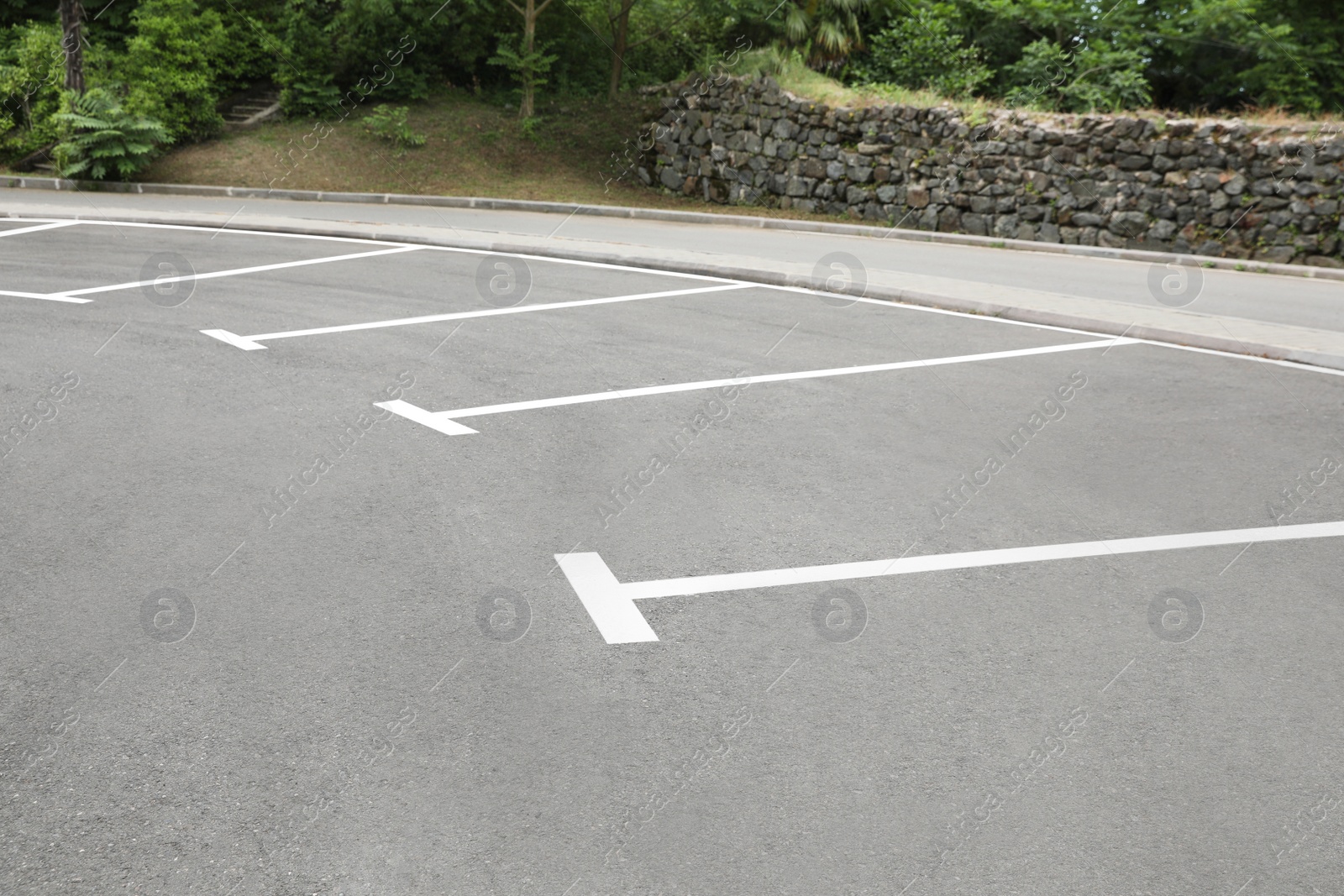 Photo of Empty outdoor parking lot with painted markings on asphalt