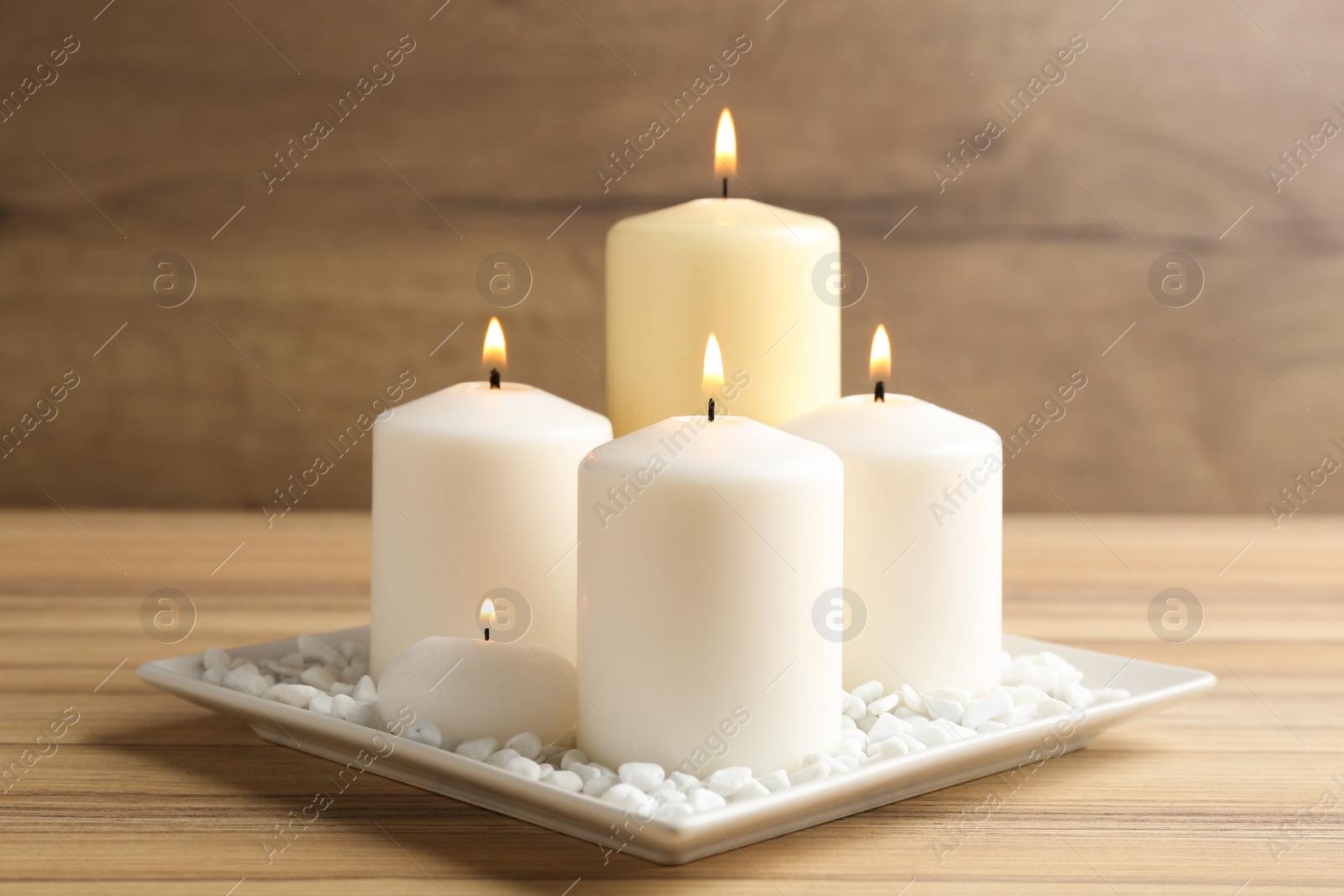Photo of Composition with burning candles on wooden table