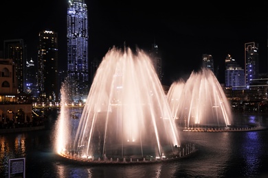 Photo of DUBAI, UNITED ARAB EMIRATES - NOVEMBER 04, 2018: Famous dancing fountain show on Burj Khalifa lake at night