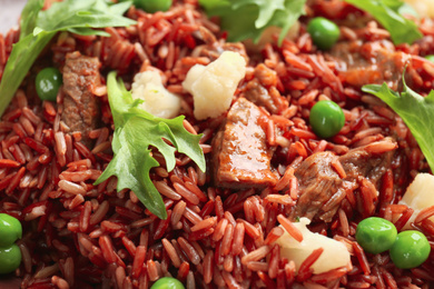 Photo of Tasty brown rice with meat and vegetables as background, closeup