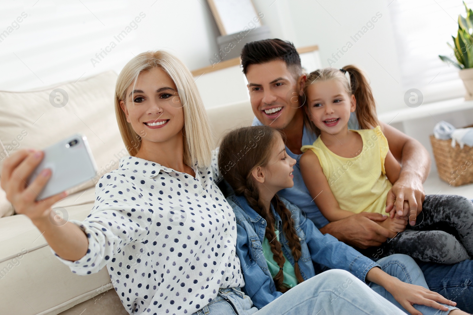 Photo of Happy family taking selfie on floor at home