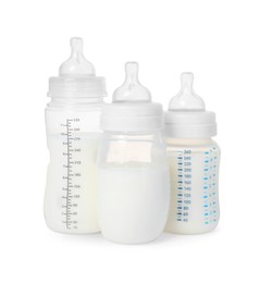 Three feeding bottles with infant formula on white background