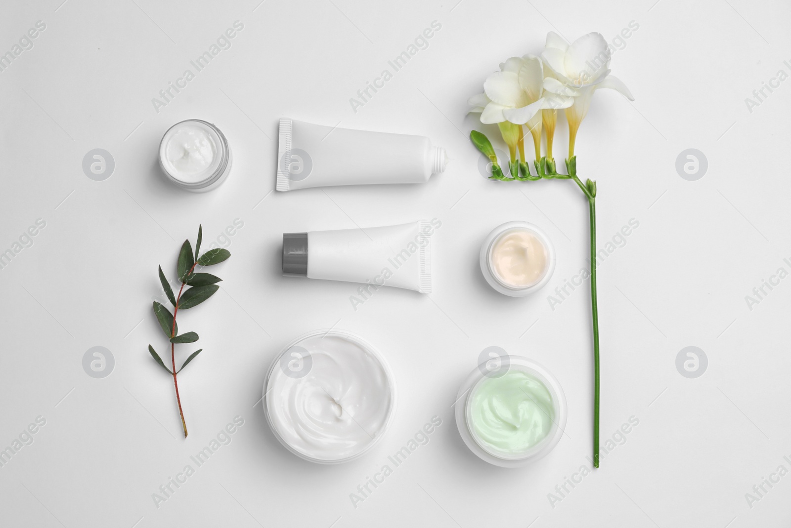 Photo of Flat lay composition with cosmetic products on light background