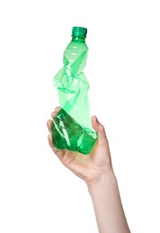 Photo of Woman holding crumpled plastic bottle on white background, closeup