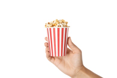 Photo of Woman holding cup with delicious popcorn on white background, closeup